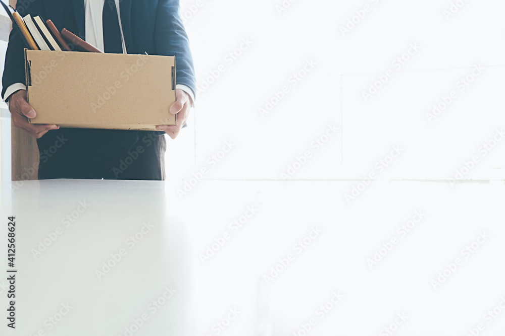 Sad dismissed businessman sitting outside the office after losing his job Sad dismissed businessman sitting outside the office after losing his job
