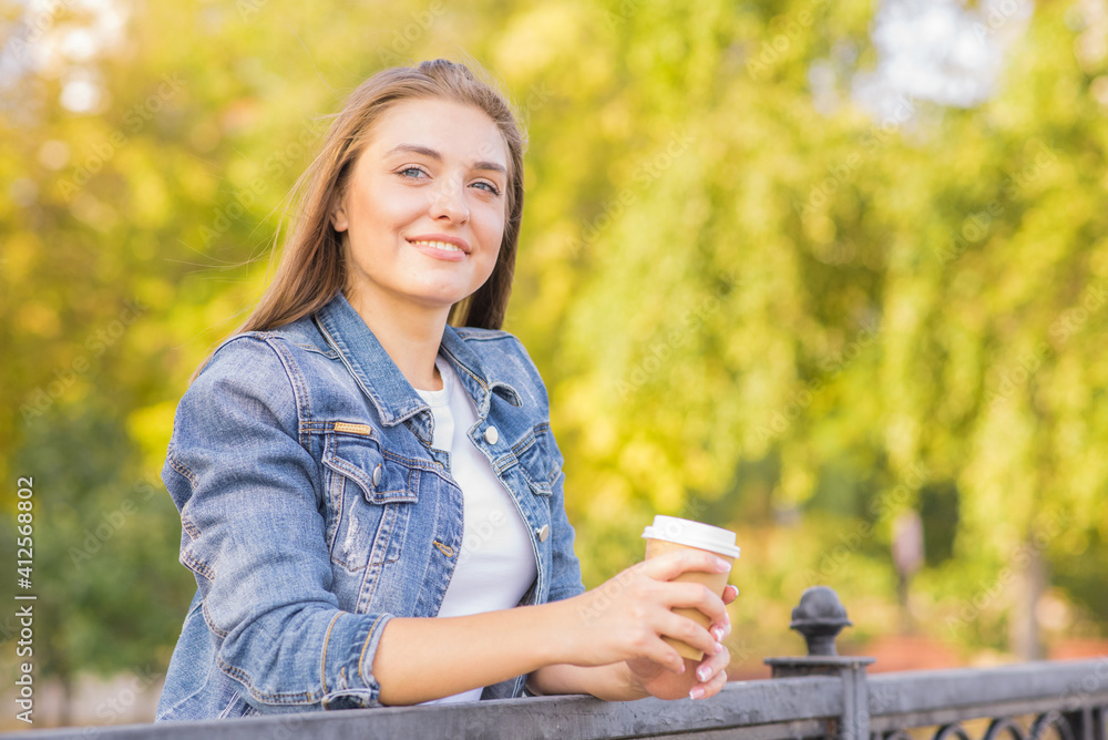 Portrait of a young, happy and pretty blonde girl with a cup of coffee in her hands Portrait of a young, happy and pretty blonde girl with a cup of coffee in her hands
