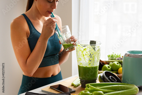 Woman drinking a green smoothie