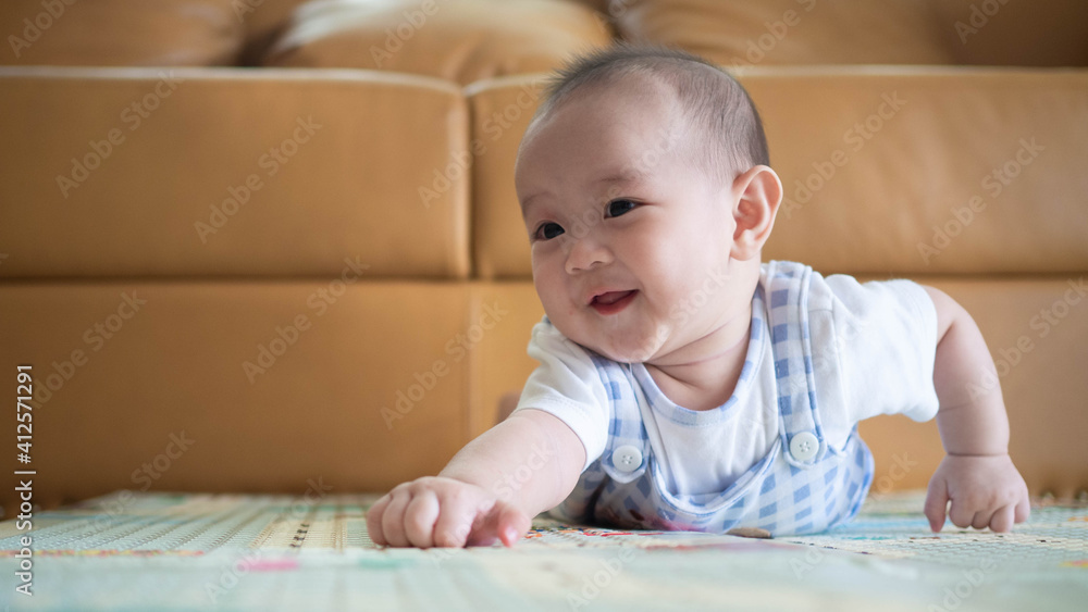 Infant child baby boy kid happy smiling screaming lying on a floor. Closeup portrait Infant child baby boy kid happy smiling screaming lying on a floor. Closeup portrait
