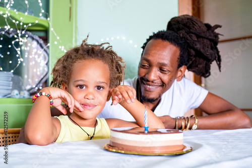 Canvas Print portrait of happy mixed race son and african father, celebration with chocolate