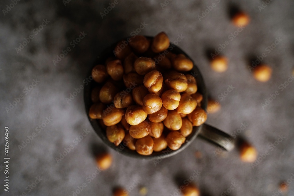 Roasted Chickpeas on dark moody background, selective focus Roasted Chickpeas on dark moody background, selective focus
