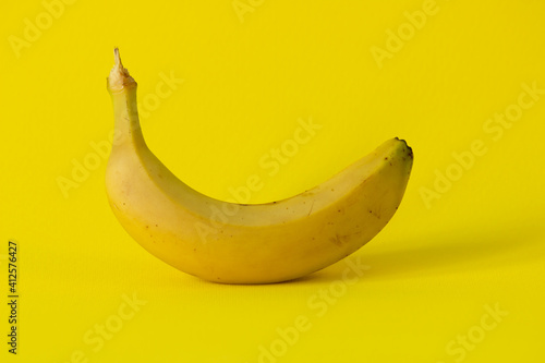 Natural bananas on a bright yellow background