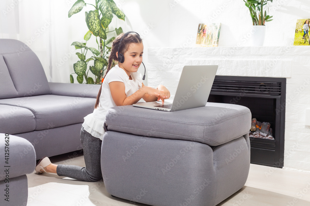 Little girl kid studen studying online class with laptop at home, New normal. Covid-19 coronavirus. Social distancing, home schooling. Little girl kid studen studying online class with laptop at home, New normal. Covid-19 coronavirus. Social distancing, home schooling.