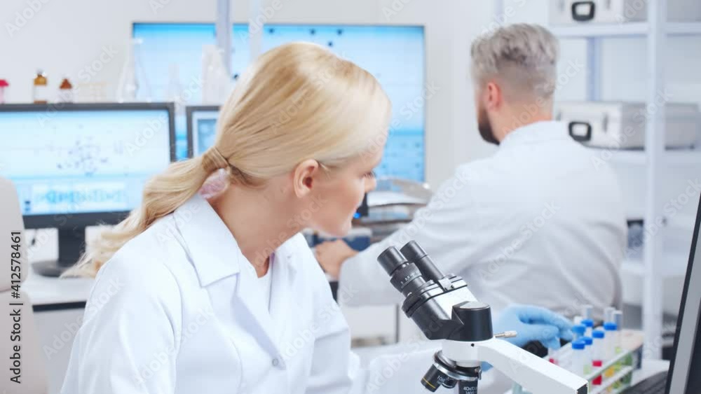 Professional team of scientists is working on a vaccine in a modern scientific research laboratory. Genetic engineer workplace. Future technology and science. Professional team of scientists is working on a vaccine in a modern scientific research laboratory. Genetic engineer workplace. Future technology and science.