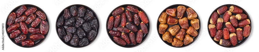 Mixed dates on a black plate, isolated on white, from above Mixed dates on a black plate, isolated on white, from above