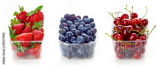 Various berries in plastic container box isolated on white