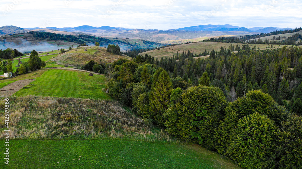 Drone shot of summer mountains landscape. Aerial view of panoramic overview of nature travel green tree forest. 
