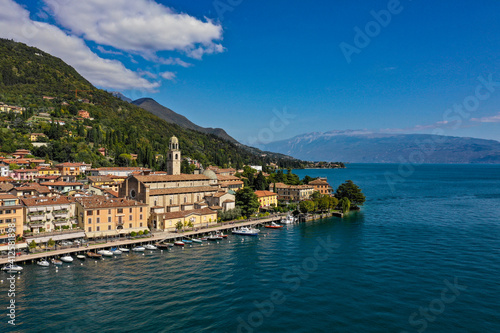 Special View by Drone - Flying in Garda lake - Salò for an italian summer. Tourist on the lake. Conca d'oro