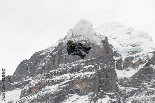 Snowboard ski freestyle big air contest in the background Mittelhorn mountain. Snowboard tricks, ski tricks. Jungfrau region Switzerland photo