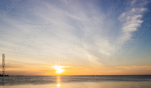 Sunset sky over sea in the evening on twilight with colorful sunlight clouds, dusk sky. © Nature Peaceful 