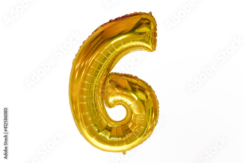 Letter six made of chrome gold inflatable balloon isolated on white background . 6 made of gold balloons isolated on white background . English 6 from gold balloons isolated on white background .