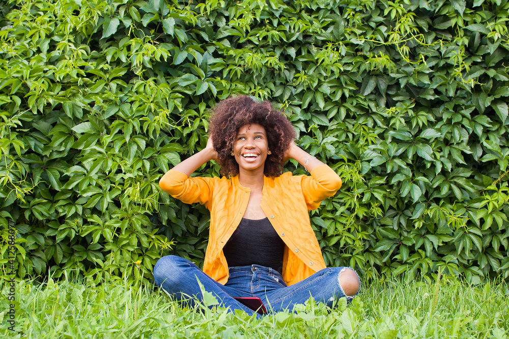 the Happy and young African American woman on the street having fun the Happy and young African American woman on the street having fun