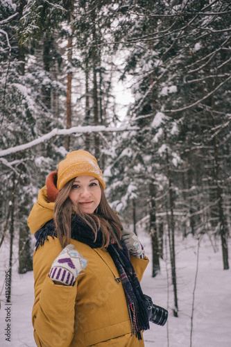 Young Cheerful woman spending time in winter snowy forest. Having fun in winter holidays © lamapacas