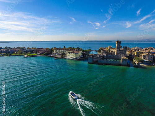 motorboat sails towards Rocca Scaligera Castle in Sirmione.
Garda Lake - Italy view by Drone
