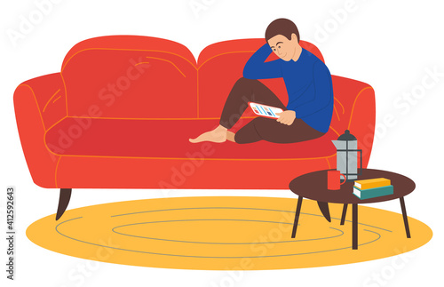 Man sitting on the sofa at home and correspondence surfing the Internet. Male character communicating through network on the tablet. Social media network communication digital gadget addiction