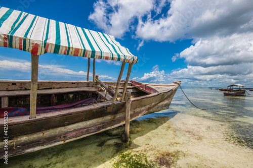 tipical boat in wood of Zanzibar in Ocean Pacific with low tide. Africa - Tanzania - Zanzibar. Holidays in Africa. Life Free and see the world
