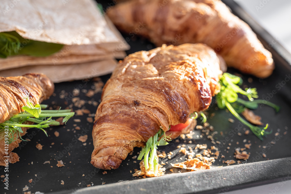 Croissant and pita with cheese, microgreen sprouts