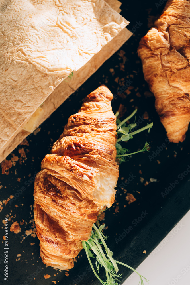 Croissant and pita with cheese, microgreen sprouts