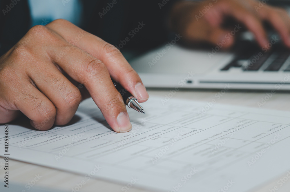 manager holds the pen of job application documents on the desk manager holds the pen of job application documents on the desk