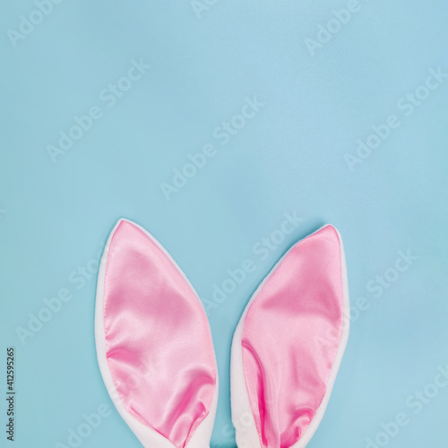 Decorative pink bunny ears on blue background.
