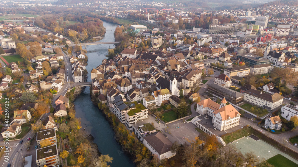 Drone view of cityscape Brugg north-east with Aare river, residential and commercial districts, historic old town and casino bridge in canton Aargau in Switzerland. Town situated on feet of Tafeljura.