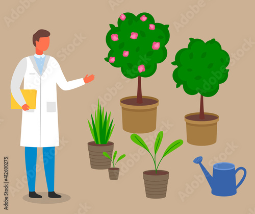 Male scientist, botanist studies and analyzes the plant. Cultivation and processing of plant. Laboratory worker man in a scientist uniform studying different vegetation rules for care and watering