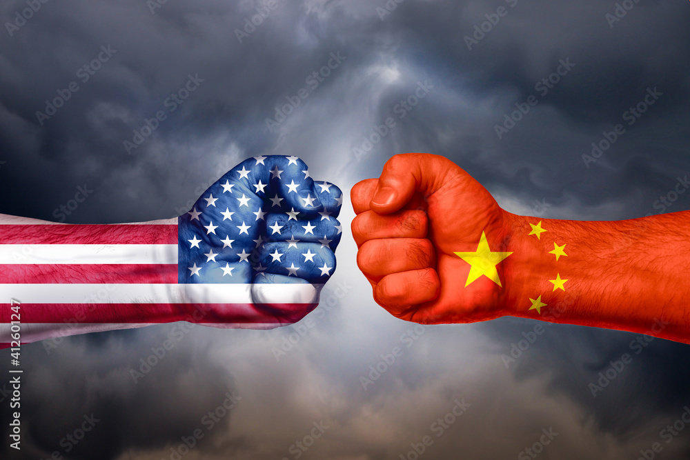 Flags Of Usa And China Painted On Two Fists On Sky Background United Flags Of Usa And China Painted On Two Fists On Sky Background United