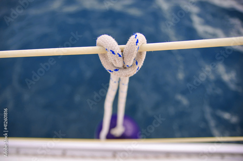 Nautical knot close up. Sailing concept. Hanging fender of the sailing boat