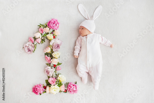 The first month of a baby's life. Newborn baby girl dressed as a bunny. Sweet newborn baby. First photo session of the baby. One month old baby.