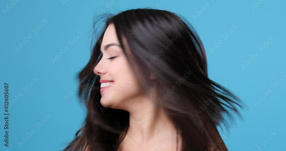 Beautiful confident woman shaking head and showing her healthy natural long hair Beautiful confident woman shaking head and showing her healthy natural long hair