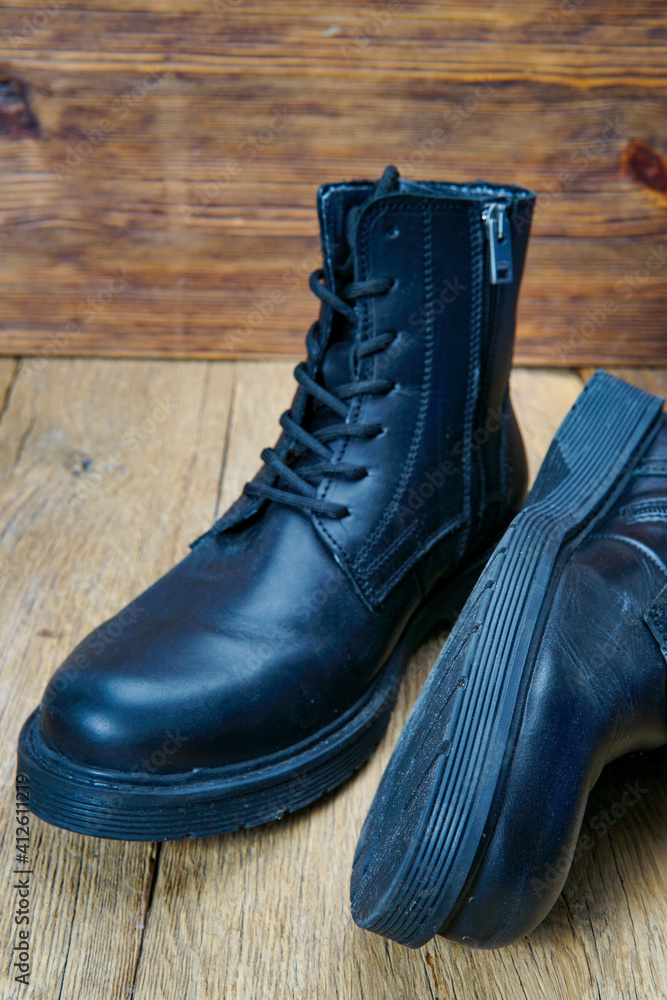 Closeup of beautiful and comfortable winter men's shoes on wooden background. Closeup of beautiful and comfortable winter men's shoes on wooden background.