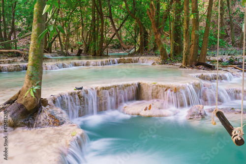 Fototapeta Naklejka Na Ścianę i Meble -  Waterfall in deepwooden swing in Wang Kan Luang Waterfall for relaxation natural therapy, Lopburi province Thailand rain forest jungle at Wang Kan Luang Waterfall, Lopburi province Thailand
