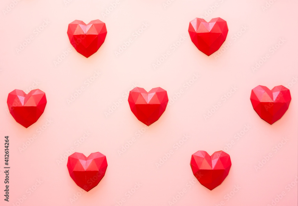 Holiday background for Valentine's Day, Red polygonal paper heart shapes on a cream background. Love concept. Plain. Minimalistic style. Holiday background for Valentine's Day, Red polygonal paper heart shapes on a cream background. Love concept. Plain. Minimalistic style.