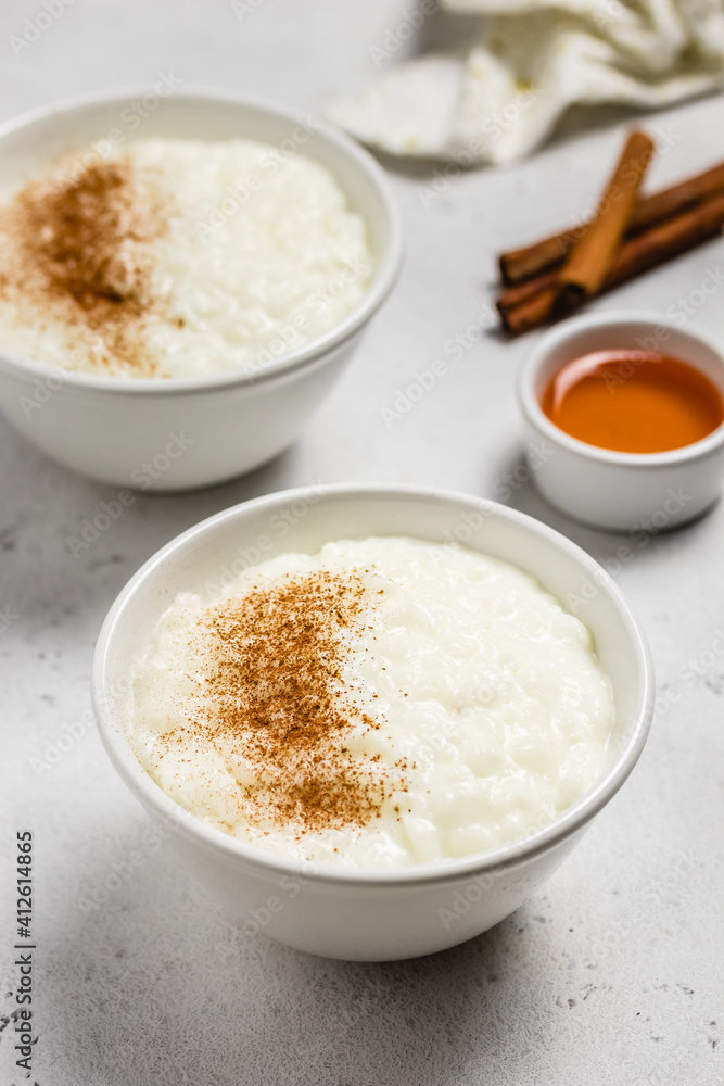 Cinnamon rice pudding in bowls. Space for text. Cinnamon rice pudding in bowls. Space for text.