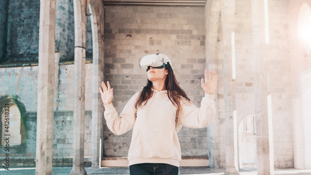 Woman wearing vr headset in european city street, virtual travel, virtual sightseeing concept. Virtual reality to travel the world idea