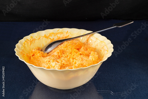 Carrot with mayonnaise and garlic in plate on glass table