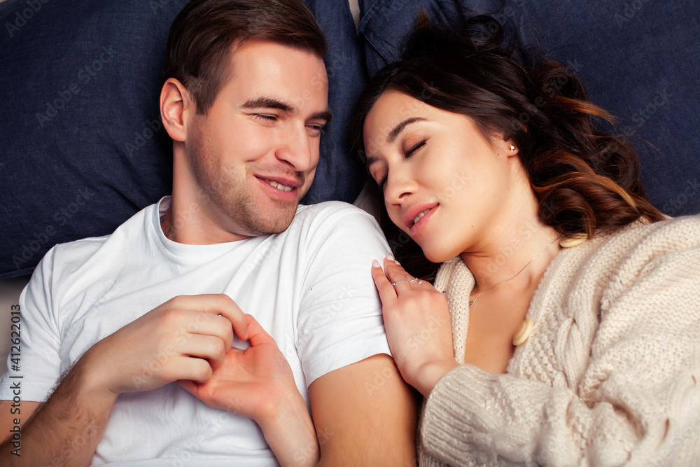 young pretty couple together in bed sleeping chill, lifestyle people concept young pretty couple together in bed sleeping chill, lifestyle people concept