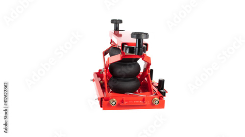 Red car traverse for repair and lifting of equipment in working form on a white background, isolation