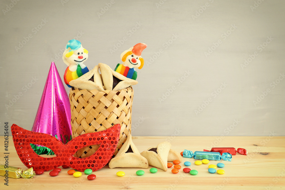Purim celebration concept (jewish carnival holiday) over wooden table Purim celebration concept (jewish carnival holiday) over wooden table
