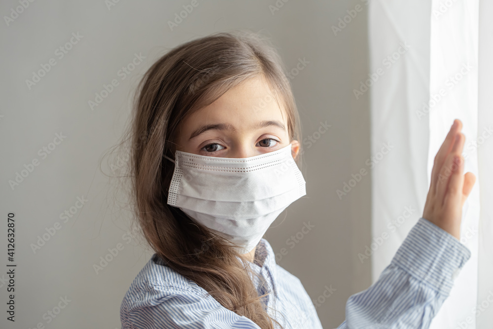 Little girl wearing a protective medical mask from coronavirus close up. Little girl wearing a protective medical mask from coronavirus close up.