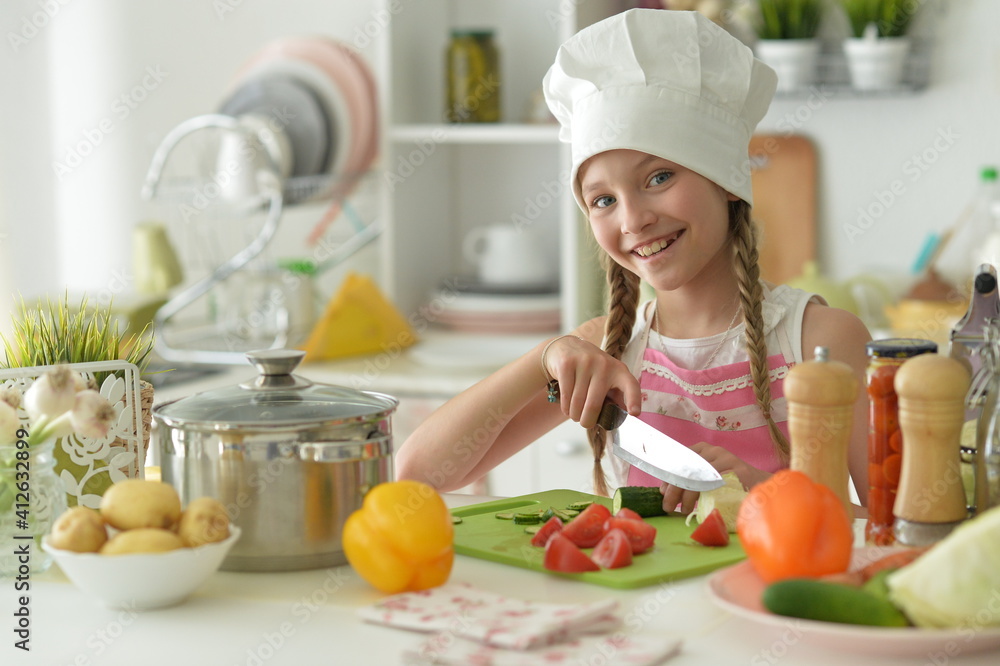 Cute happy girl coocking on kitchen Cute happy girl coocking on kitchen