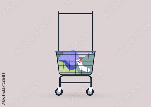 Household chores concept, a coin laundromat trolley loaded with colorful clothes