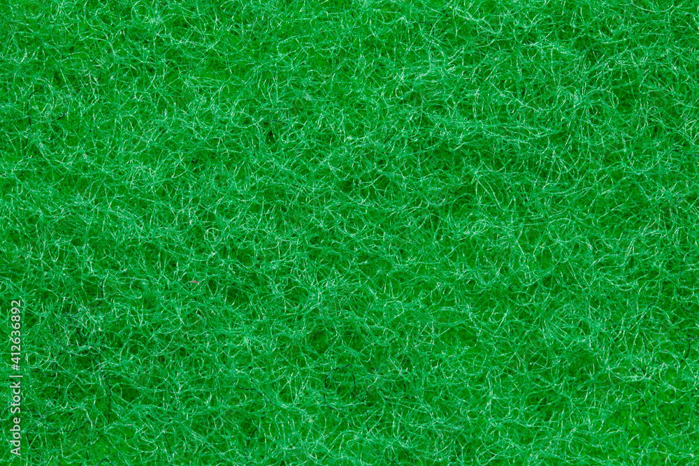 Green sponge texture. Closeup of the rough side of a kitchen sponge for cleaning of of pots and pans. Cellulose or foam sponge background. Macro. Green sponge texture. Closeup of the rough side of a kitchen sponge for cleaning of of pots and pans. Cellulose or foam sponge background. Macro.