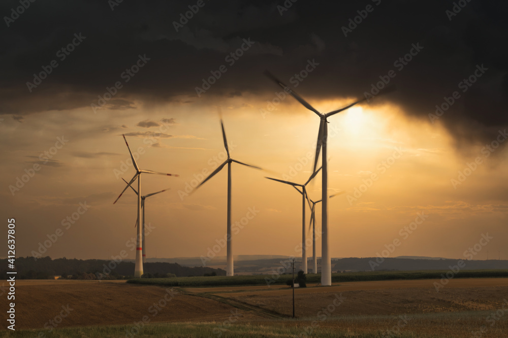 wind turbines on field in bad weather