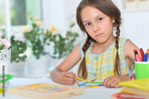 Cute girl learning to count with sticks at room