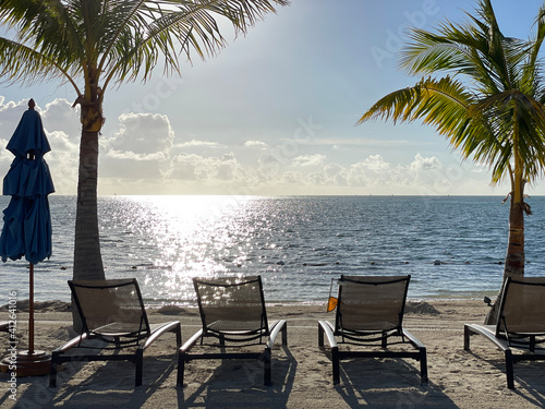 chairs on the beach at sunset