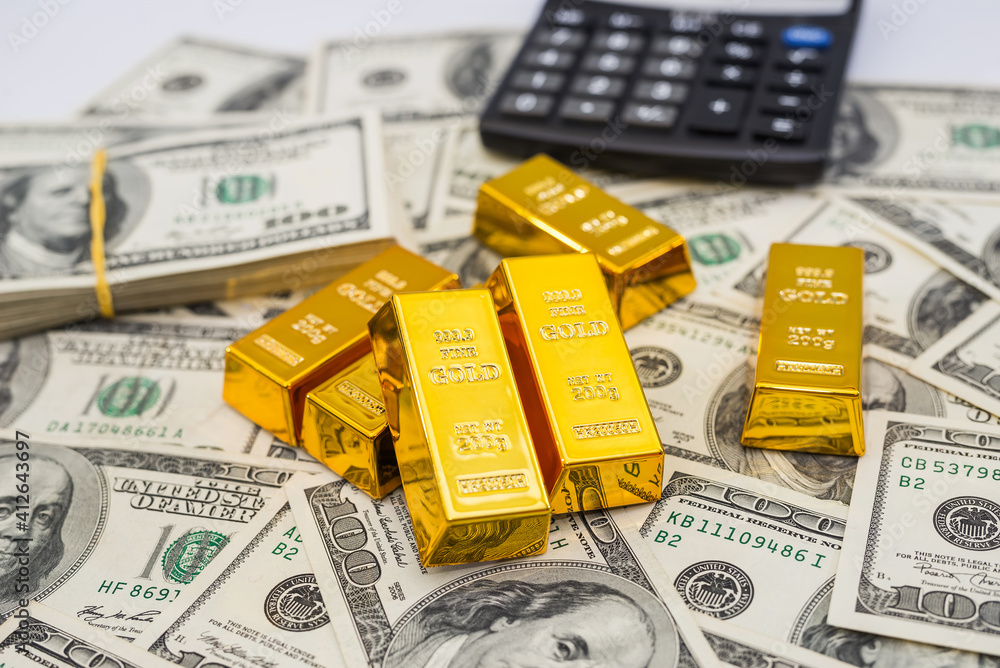 gold bars and calculator on 100 new US dollar banknotes. gold bars and calculator on 100 new US dollar banknotes.
