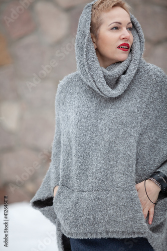Portrait of beautiful woman in gray sweater