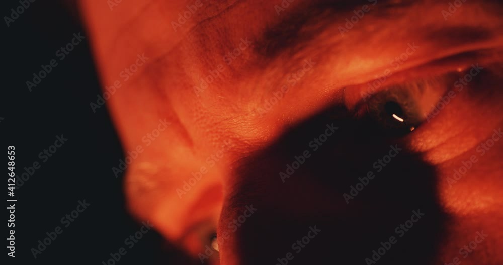 Macro close up of eye doused in red light